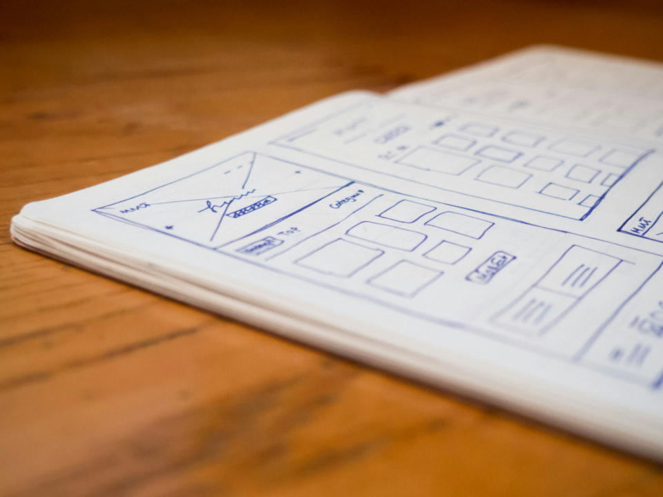 Website wireframes sketched on paper